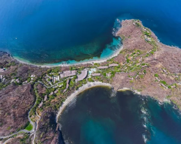 Aerial view of a rocky island coastline: Maldives All-Inclusive Costs and How to Pay Less