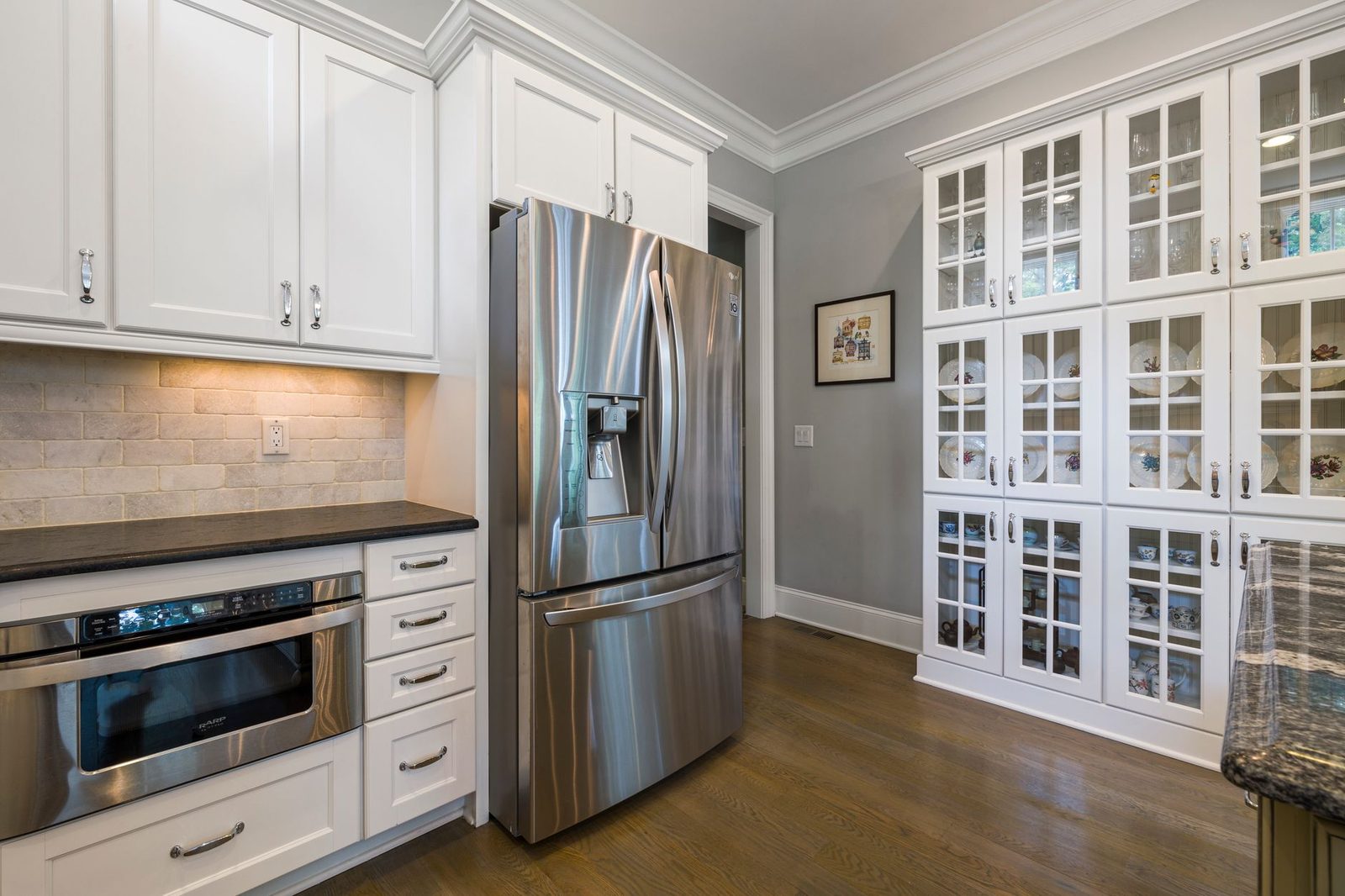 Kitchen remodel completed by Friends Enterprises featuring new cabinets and stainless steel appliances.