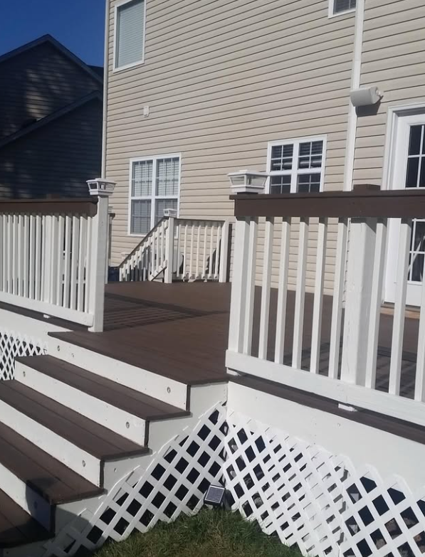 The same deck and siding after washing and a fresh finish