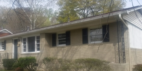 A ranch home exterior before repainting